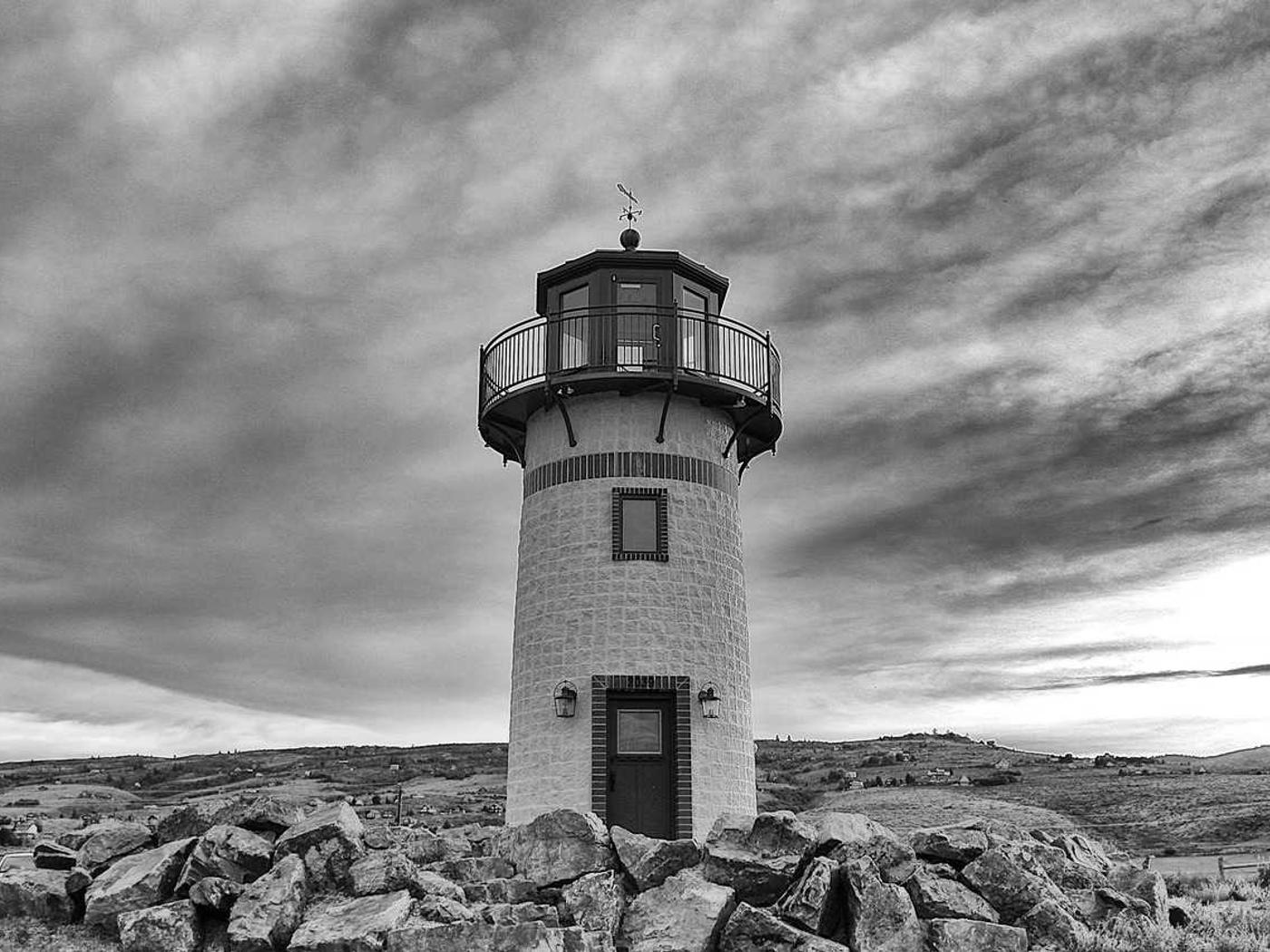 A lighthouse standing on a rocky coastline.